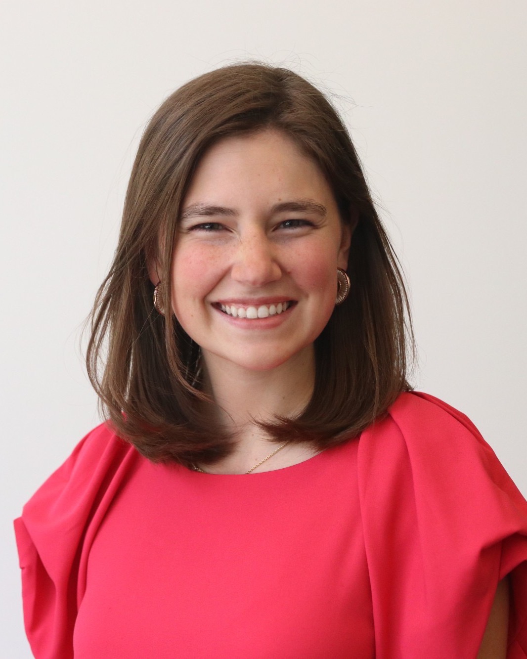 Kate Hester, smiling, in a pink top