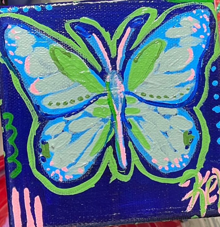Small painting of a pale blue butterfly on deep blue