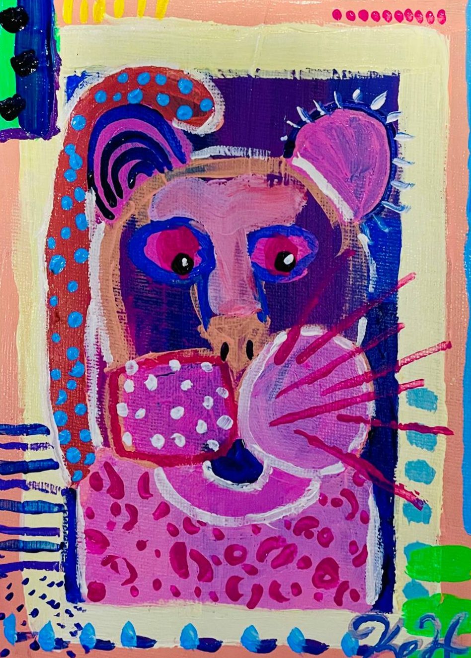 Small painting of a pink cat face framed in pastel patterns